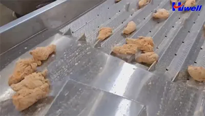 Ligne d’enrobage de pilons de poulet